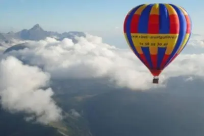 a colorful hot air balloon flying over the clouds at Super appartement Cocooning vu Mont Blanc in Sallanches