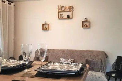 a living room with a table with two wine glasses at Super appartement Cocooning vu Mont Blanc in Sallanches