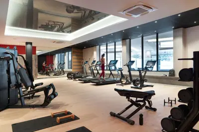 a gym with a lot of treadmills and exercise bikes at MGM Hôtels & Résidences - Hôtel Alhéna in Flaine
