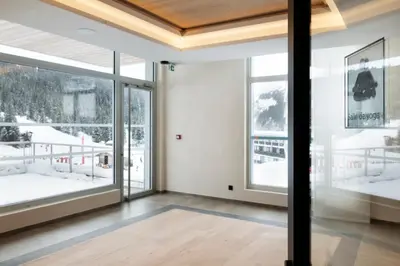 a room with large windows and a view of the snow at MGM Hôtels & Résidences - Hôtel Alhéna in Flaine