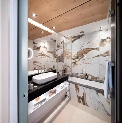 a bathroom with marble walls and a sink at MGM Hôtels & Résidences - Hôtel Alhéna in Flaine