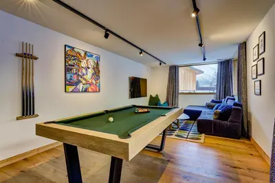 a living room with a pool table in it at Chalet Trois Soeurs in Chamonix-Mont-Blanc
