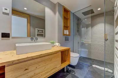 a bathroom with a white sink and a shower at Chalet Trois Soeurs in Chamonix-Mont-Blanc