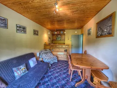 a living room with a couch and a table at Appart. 38m² pour 6 pers, balcon sud, pied des pistes - FR-1-687-115 in Arâches-la-Frasse