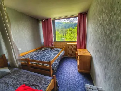 a small room with two beds and a window at Appart. 38m² pour 6 pers, balcon sud, pied des pistes - FR-1-687-115 in Arâches-la-Frasse