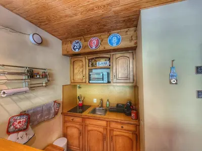 a kitchen with wooden cabinets and a sink at Appart. 38m² pour 6 pers, balcon sud, pied des pistes - FR-1-687-115 in Arâches-la-Frasse