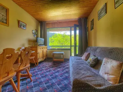 a living room with a couch and a table and a desk at Appart. 38m² pour 6 pers, balcon sud, pied des pistes - FR-1-687-115 in Arâches-la-Frasse