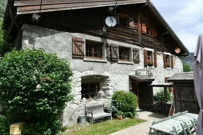 a building with a clock on the side of it at Le Vallorcin, chalet le Sizeray vallée de Chamonix & Mont Blanc - by ImmoConciergerie in Vallorcine