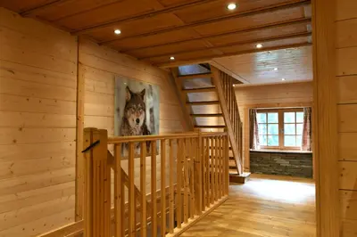a staircase in a log cabin with a picture of a wolf at Le Vallorcin, chalet le Sizeray vallée de Chamonix & Mont Blanc - by ImmoConciergerie in Vallorcine