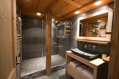 a bathroom with a shower with a sink and a mirror at Les Posettes, chalet vallée de Chamonix - Mont Blanc by ImmoConciergerie in Vallorcine