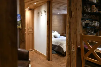a bedroom with a bed in a room with wooden walls at Les Posettes, chalet vallée de Chamonix - Mont Blanc by ImmoConciergerie in Vallorcine
