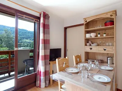 a living room with a couch and a table at Studio Les chalets du soleil by Interhome in Saint-Gervais-les-Bains