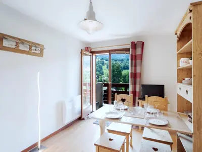 a bathroom with a toilet and a sink and a window at Studio Les chalets du soleil by Interhome in Saint-Gervais-les-Bains