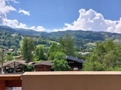 a room with a couch with red pillows and a table at Studio Les chalets du soleil by Interhome in Saint-Gervais-les-Bains
