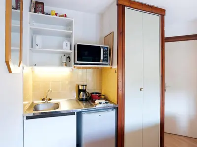 a small kitchen with a sink and a microwave at Studio Les chalets du soleil by Interhome in Saint-Gervais-les-Bains