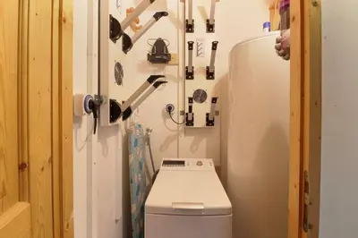 a small bathroom with a refrigerator and a toilet at Le Quatre - 75m2 Charmant Duplex - Central - 8-10 pax 3ch in Saint-Gervais-les-Bains