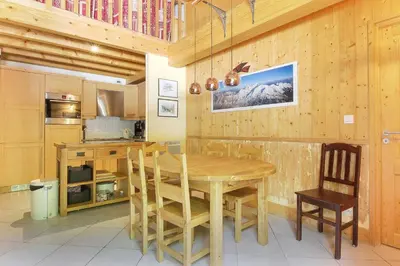 a wooden kitchen with a wooden table and chairs at Le Quatre - 75m2 Charmant Duplex - Central - 8-10 pax 3ch in Saint-Gervais-les-Bains