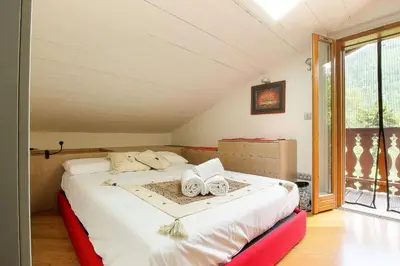 a bedroom with a bed with two towels on it at Appartement Yoga - Vues Chaîne du Mont-Blanc - Calme - Espace Yoga Spacieux in Les Houches