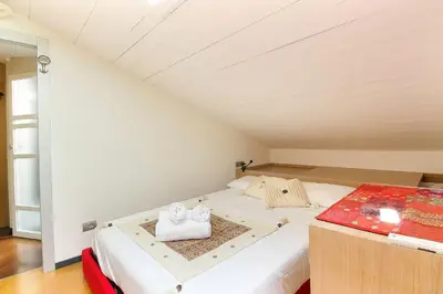 a bedroom with a bed with two towels on it at Appartement Yoga - Vues Chaîne du Mont-Blanc - Calme - Espace Yoga Spacieux in Les Houches