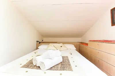 a bed in a attic with towels on it at Appartement Yoga - Vues Chaîne du Mont-Blanc - Calme - Espace Yoga Spacieux in Les Houches