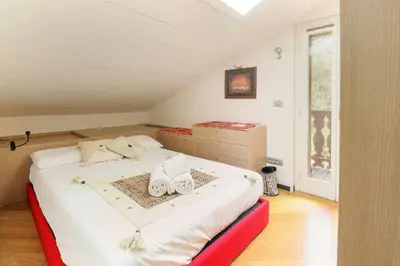a bedroom with a bed with shoes on it at Appartement Yoga - Vues Chaîne du Mont-Blanc - Calme - Espace Yoga Spacieux in Les Houches