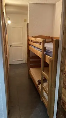 a room with two bunk beds and a door at Studio avec coin montagne au pied des pistes in Megève