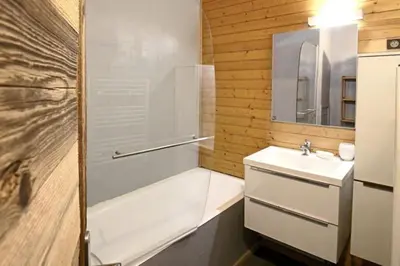 a bathroom with a bath tub and a sink and a bath tub at Studio avec coin montagne au pied des pistes in Megève