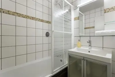 a white bathroom with a sink and a shower at Apartment Grepon 6 Incredible Mont Blanc View Chamonix in Chamonix-Mont-Blanc