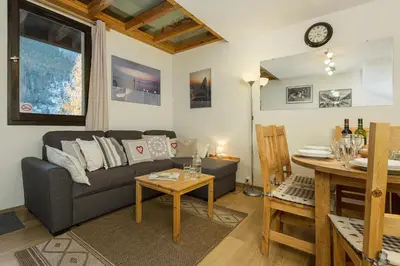 a living room with a couch and a table at Apartment Grepon 6 Incredible Mont Blanc View Chamonix in Chamonix-Mont-Blanc