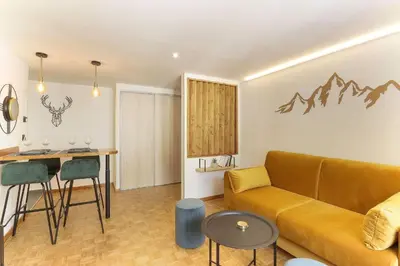 a living room with a couch and a table at Bellevarde Apt - Newly Renovated - Central - Beside TMB start/end in Les Houches