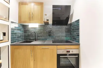 a kitchen with a sink and a stove at Bellevarde Apt - Newly Renovated - Central - Beside TMB start/end in Les Houches