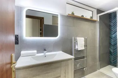 a bathroom with a sink and a mirror at Bellevarde Apt - Newly Renovated - Central - Beside TMB start/end in Les Houches