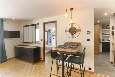 a kitchen and living room with a table and chairs at Bellevarde Apt - Newly Renovated - Central - Beside TMB start/end in Les Houches