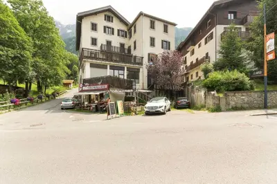 a building with a car parked in a parking lot at Bellevarde Apt - Newly Renovated - Central - Beside TMB start/end in Les Houches