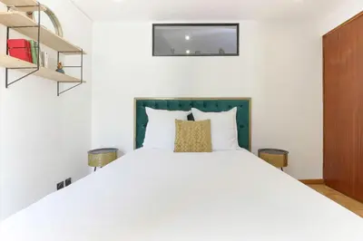 a bedroom with a large white bed and shelves at Bellevarde Apt - Newly Renovated - Central - Beside TMB start/end in Les Houches