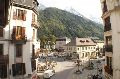 a view of a street in a town with mountains at Apartment Relais de Poste Centre Chamonix Mont Blanc in Chamonix-Mont-Blanc