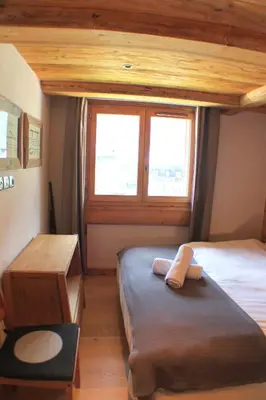 a small bedroom with two beds and a window at Apartment Planards Centre Chamonix foot of the Planards Slopes in Chamonix-Mont-Blanc