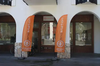 a building with orange signs in front of a store at Apartment Planards Centre Chamonix foot of the Planards Slopes in Chamonix-Mont-Blanc