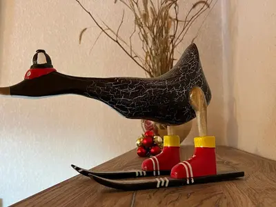 a bird statue sitting on top of a table at Appartement mansardé 2 pièces avec piscine et wifi - FR-1-629-124 in Samoëns