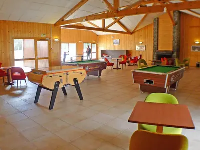 a large room with several tables and pool tables at Appartement mansardé 2 pièces avec piscine et wifi - FR-1-629-124 in Samoëns