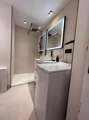 a white bathroom with a sink and a mirror at Vue Mont blanc, ski et village in Combloux