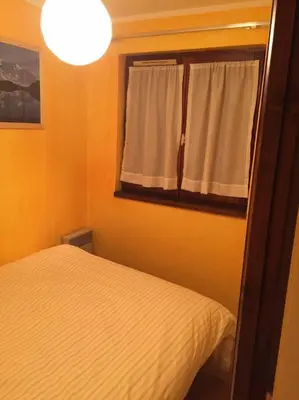 a bedroom with a white bed and a window at Chamonix centre - 2 pièces 32 m2 in Chamonix-Mont-Blanc