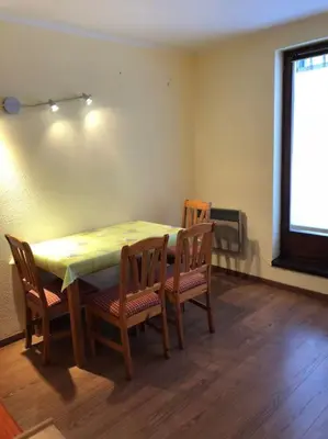 a table and chairs in a room with a window at Chamonix centre - 2 pièces 32 m2 in Chamonix-Mont-Blanc