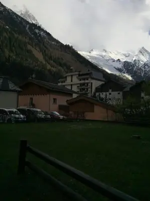 a field with a fence in front of a mountain at Chamonix centre - 2 pièces 32 m2 in Chamonix-Mont-Blanc