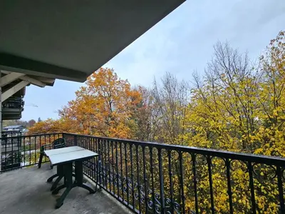 a white bench on a balcony with trees at Le grand panorama appartement 2 chambres 4 adultes 2 enfants in Saint-Gervais-les-Bains