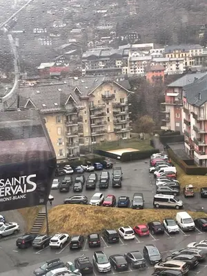 a parking lot full of cars in a city at Le grand panorama appartement 2 chambres 4 adultes 2 enfants in Saint-Gervais-les-Bains