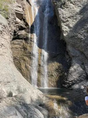 a waterfall on the side of a rocky mountain at Le grand panorama appartement 2 chambres 4 adultes 2 enfants in Saint-Gervais-les-Bains