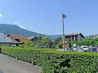 a street with cars parked in a parking lot at Appartement rénové avec terrasse et parking, fibre incluse - FR-1-629-127 in Samoëns