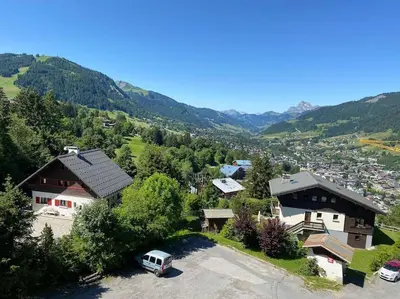 an aerial view of a house with a parking lot at superbe appartement avec vue sur montagnes, calme in Megève