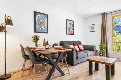 a living room with a table and a couch at Apartment Le Panoramic in Chamonix-Mont-Blanc